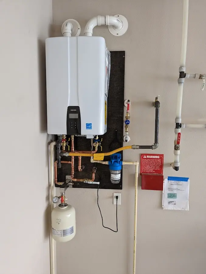 Professional plumber installing copper piping in a Buena Vista home